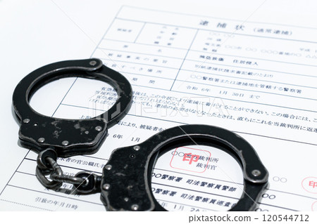 Image of a dark job: arrest warrant and black handcuffs Image of a dark job: arrest warrant and black handcuffs 120544712