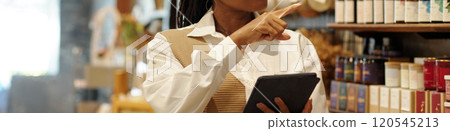 Smiling Woman Choosing Wine in Vineyard Shop 120545213