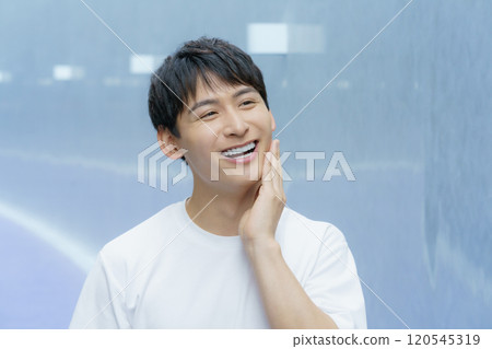 Young man touching his cheek, beauty boy Young man touching his cheek, beauty boy 120545319