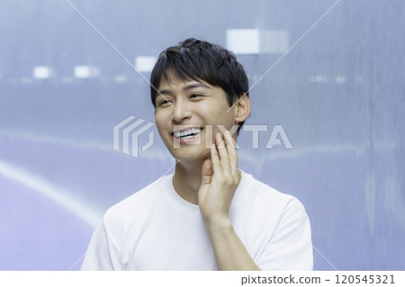 Young man touching his cheek, beauty boy 120545321