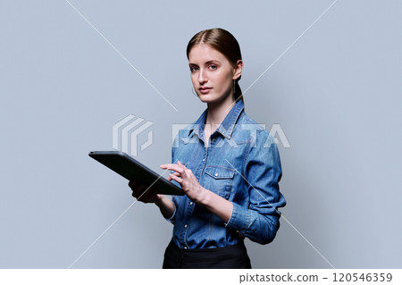 Teenager student girl with digital tablet on grey studio background 120546359