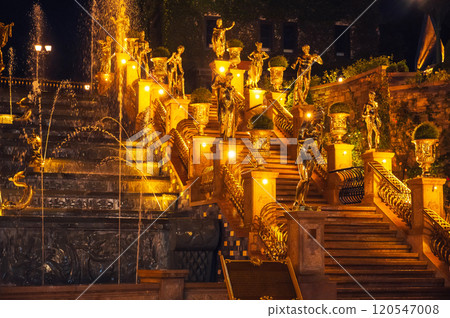 Fountain with cascades decorated with statues illuminated at night Fountain with cascades decorated with statues illuminated at night 120547008