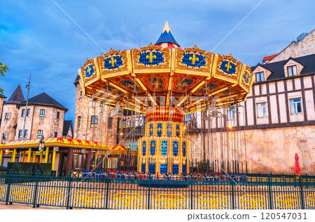 Festive chain carousel on the square of medieval city in Europe 120547031