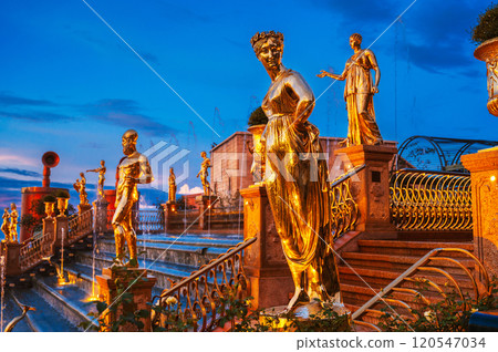 Antique golden statues on cascade of fountains in Ba Na Hills Park in Da Nang in Vietnam at evening 120547034