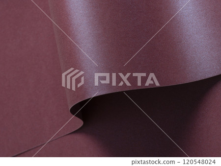 Burgundy metallic paper background with a shimmering, sleek surface and soft folds. Featuring a rich Burgundy metallic paper background with a shimmering, sleek surface and soft folds. Featuring a rich 120548024