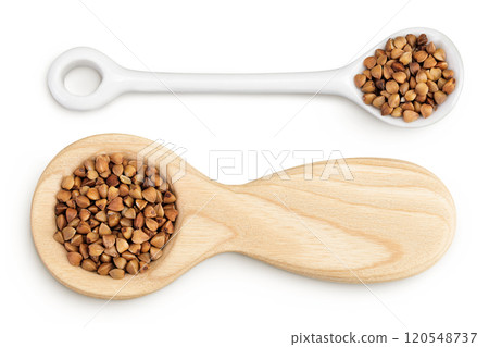 Raw buckwheat in wooden and ceramic spoon isolated on white background. Top view. Flat lay Raw buckwheat in wooden and ceramic spoon isolated on white background. Top view. Flat lay 120548737
