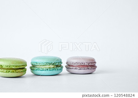 Row of three colorful French Macarons, macaroons cakes with different flavors Row of three colorful French Macarons, macaroons cakes with different flavors 120548824
