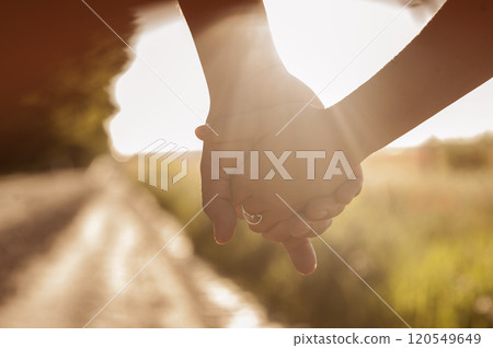 Couple holding hands at sunset.close up People holding hand together concept of love. Couple holding hands at sunset.close up People holding hand together concept of love. 120549649