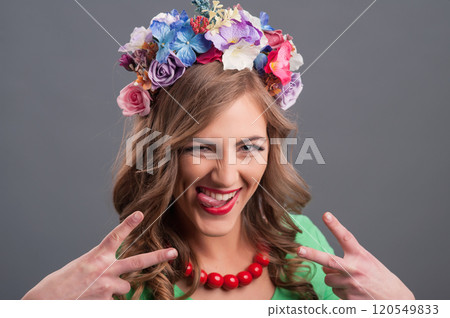 Beautiful girl with a wreath of flowers on her head.Beautiful girl in the flower garden. Princess. 120549833