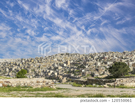 Amman city landmarks-- old roman Citadel Hill, Jordan. Against the background of a beautiful sky with clouds Amman city landmarks-- old roman Citadel Hill, Jordan. Against the background of a beautiful sky with clouds 120550061