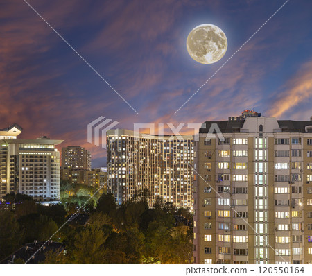 Aerial view of Moscow (night, against the sunset) and full moon, Cheryomushki district near Profsoyuznaya metro station, Russia 120550164