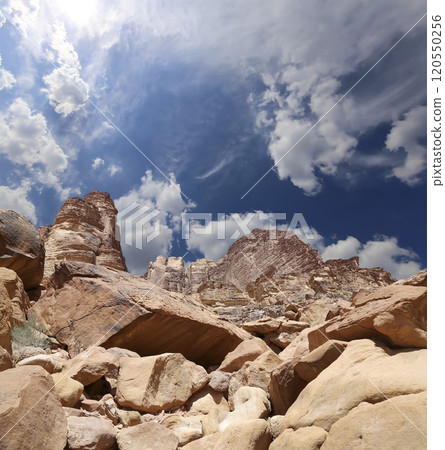 Mountains of Wadi Rum Desert also known as The Valley of the Moon is a valley cut into the sandstone and granite rock in southern Jordan 60 km to the east of Aqaba Mountains of Wadi Rum Desert also known as The Valley of the Moon is a valley cut into the sandstone and granite rock in southern Jordan 60 km to the east of Aqaba 120550256