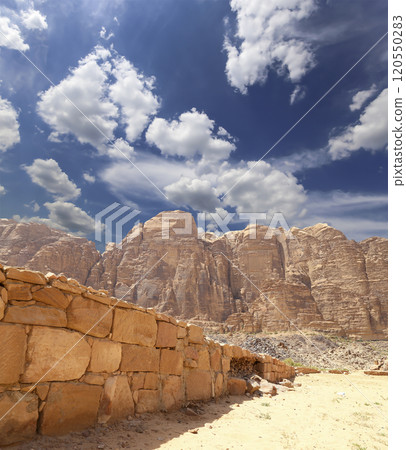 Mountains of Wadi Rum Desert also known as The Valley of the Moon is a valley cut into the sandstone and granite rock in southern Jordan 60 km to the east of Aqaba Mountains of Wadi Rum Desert also known as The Valley of the Moon is a valley cut into the sandstone and granite rock in southern Jordan 60 km to the east of Aqaba 120550283