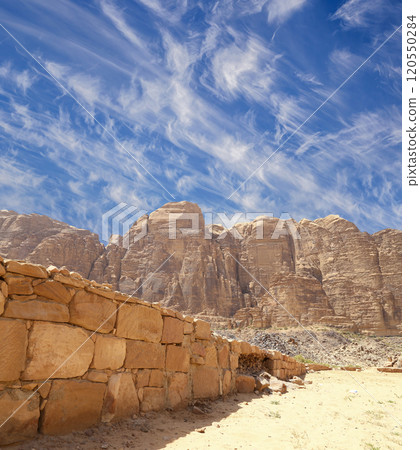 Mountains of Wadi Rum Desert also known as The Valley of the Moon is a valley cut into the sandstone and granite rock in southern Jordan 60 km to the east of Aqaba Mountains of Wadi Rum Desert also known as The Valley of the Moon is a valley cut into the sandstone and granite rock in southern Jordan 60 km to the east of Aqaba 120550284