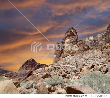 Mountains of Wadi Rum Desert also known as The Valley of the Moon is a valley cut into the sandstone and granite rock in southern Jordan 60 km to the east of Aqaba Mountains of Wadi Rum Desert also known as The Valley of the Moon is a valley cut into the sandstone and granite rock in southern Jordan 60 km to the east of Aqaba 120550313