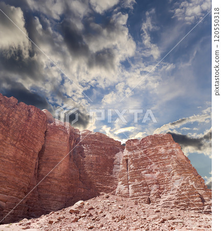 Mountains of Wadi Rum Desert also known as The Valley of the Moon is a valley cut into the sandstone and granite rock in southern Jordan 60 km to the east of Aqaba Mountains of Wadi Rum Desert also known as The Valley of the Moon is a valley cut into the sandstone and granite rock in southern Jordan 60 km to the east of Aqaba 120550318