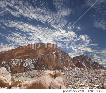 Mountains of Wadi Rum Desert also known as The Valley of the Moon is a valley cut into the sandstone and granite rock in southern Jordan 60 km to the east of Aqaba Mountains of Wadi Rum Desert also known as The Valley of the Moon is a valley cut into the sandstone and granite rock in southern Jordan 60 km to the east of Aqaba 120550336