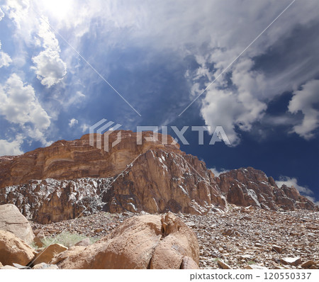 Mountains of Wadi Rum Desert also known as The Valley of the Moon is a valley cut into the sandstone and granite rock in southern Jordan 60 km to the east of Aqaba Mountains of Wadi Rum Desert also known as The Valley of the Moon is a valley cut into the sandstone and granite rock in southern Jordan 60 km to the east of Aqaba 120550337