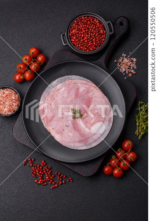 Ham cut into round slices with salt, spices and herbs Ham cut into round slices with salt, spices and herbs 120550506