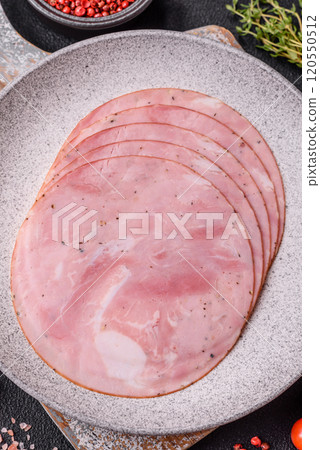 Ham cut into round slices with salt, spices and herbs Ham cut into round slices with salt, spices and herbs 120550512