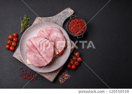 Sandwich with toast, ham, cheese, tomatoes, salt, spices and herbs 120550539