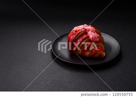 Crispy fresh red croissant with cream and strawberries Crispy fresh red croissant with cream and strawberries 120550755