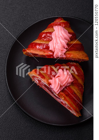 Crispy fresh red croissant with cream and strawberries Crispy fresh red croissant with cream and strawberries 120550770