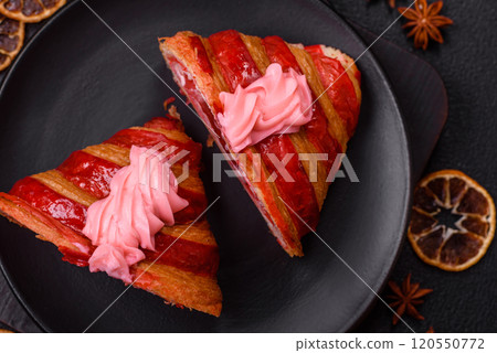 Crispy fresh red croissant with cream and strawberries 120550772
