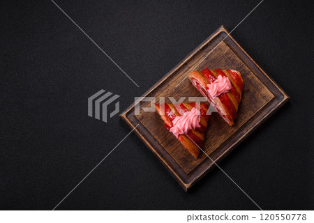 Crispy fresh red croissant with cream and strawberries Crispy fresh red croissant with cream and strawberries 120550778