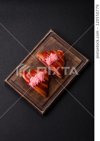 Crispy fresh red croissant with cream and strawberries Crispy fresh red croissant with cream and strawberries 120550779