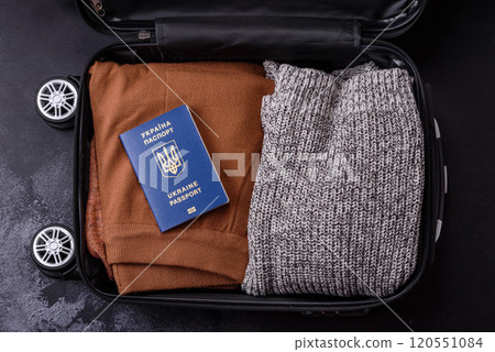 International passport of a citizen of Ukraine on a suitcase 120551084