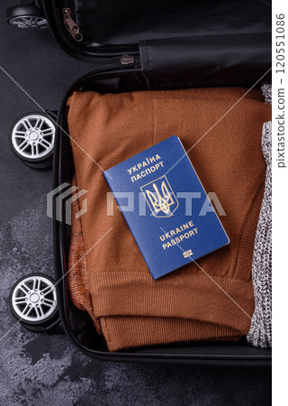 International passport of a citizen of Ukraine on a suitcase 120551086