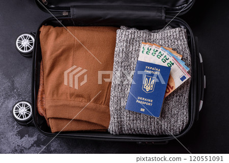 International passport of a citizen of Ukraine on a suitcase 120551091