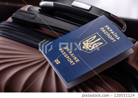 International passport of a citizen of Ukraine on a suitcase 120551124