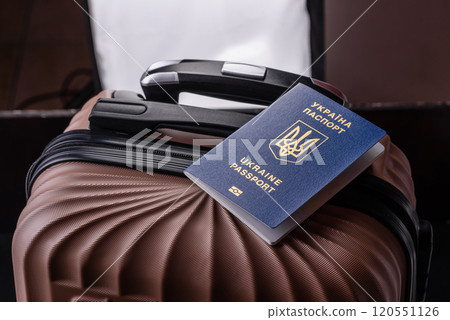 International passport of a citizen of Ukraine on a suitcase 120551126