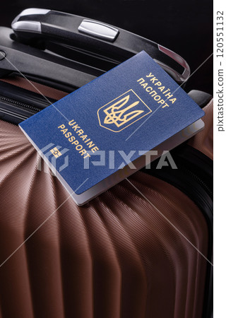 International passport of a citizen of Ukraine on a suitcase 120551132