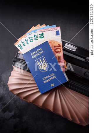 International passport of a citizen of Ukraine on a suitcase 120551139