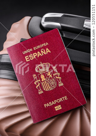 International passport of a citizen of Spain on a suitcase International passport of a citizen of Spain on a suitcase 120551151