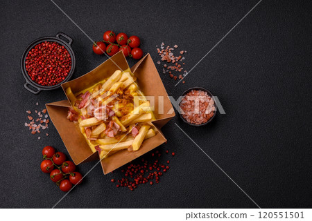Crispy French fries with pieces of bacon, salt and spices 120551501