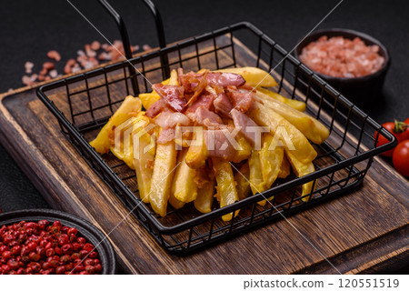 Crispy French fries with pieces of bacon, salt and spices Crispy French fries with pieces of bacon, salt and spices 120551519