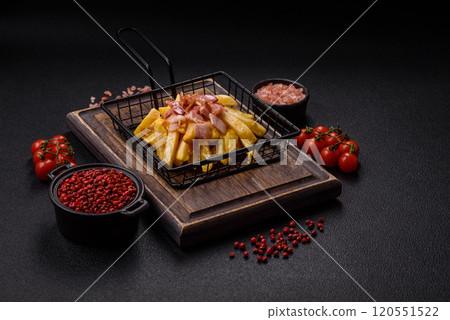 Crispy French fries with pieces of bacon, salt and spices Crispy French fries with pieces of bacon, salt and spices 120551522