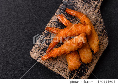 Hot crispy shrimp breaded with salt and spices with white sauce 120551601