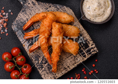 Hot crispy shrimp breaded with salt and spices with white sauce Hot crispy shrimp breaded with salt and spices with white sauce 120551603