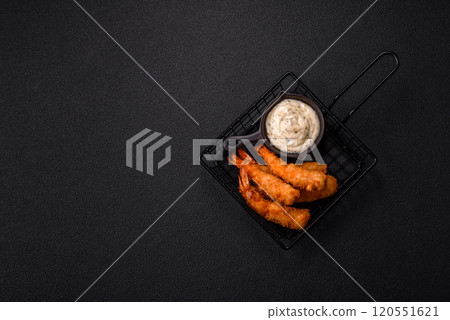 Hot crispy shrimp breaded with salt and spices with white sauce 120551621