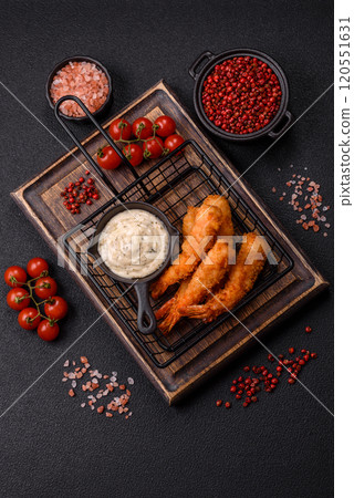 Hot crispy shrimp breaded with salt and spices with white sauce 120551631