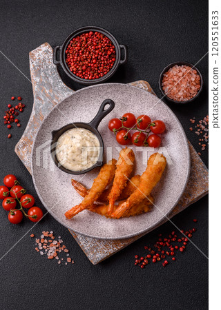 Hot crispy shrimp breaded with salt and spices with white sauce Hot crispy shrimp breaded with salt and spices with white sauce 120551633