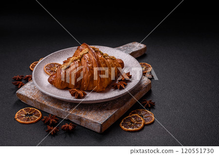 Fresh crispy croissant filled with pistachio cream 120551730