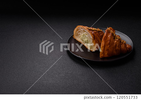 Fresh crispy croissant filled with pistachio cream 120551733