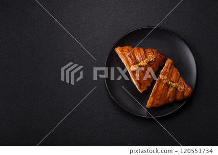 Fresh crispy croissant filled with pistachio cream 120551734