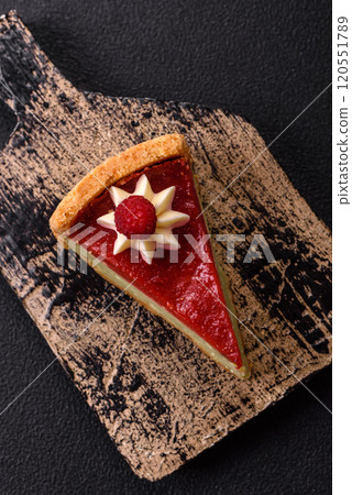 Delicious sweet dessert cheesecake with raspberry and pistachio flavor Delicious sweet dessert cheesecake with raspberry and pistachio flavor 120551789